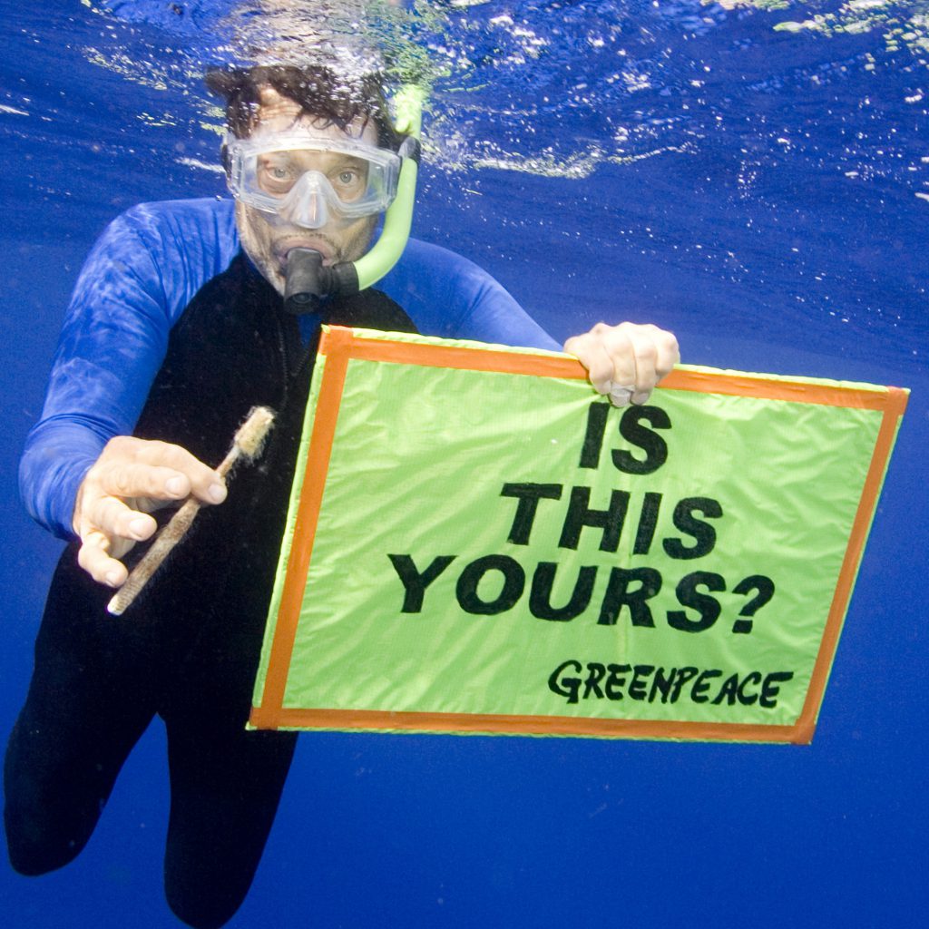 Marine conservationist Charles Moore displays a plastic toothbrush found in the ocean – image © GreenPeace
